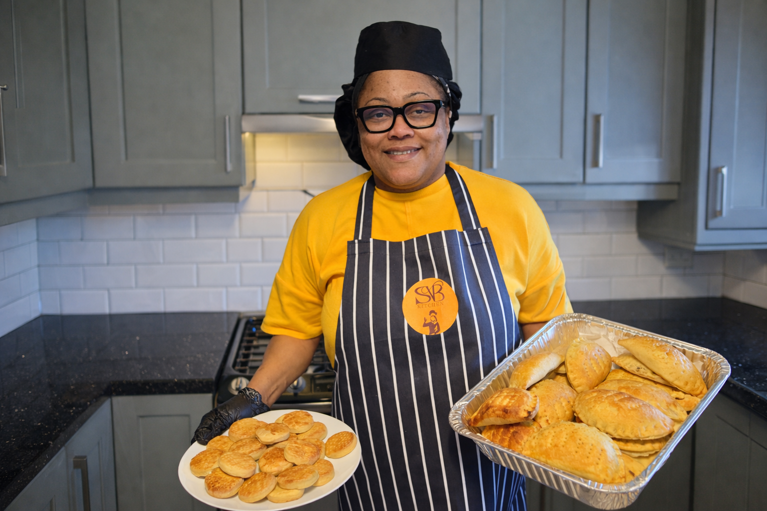 Freshly baked meat pies and golden cookies in modern kitchen